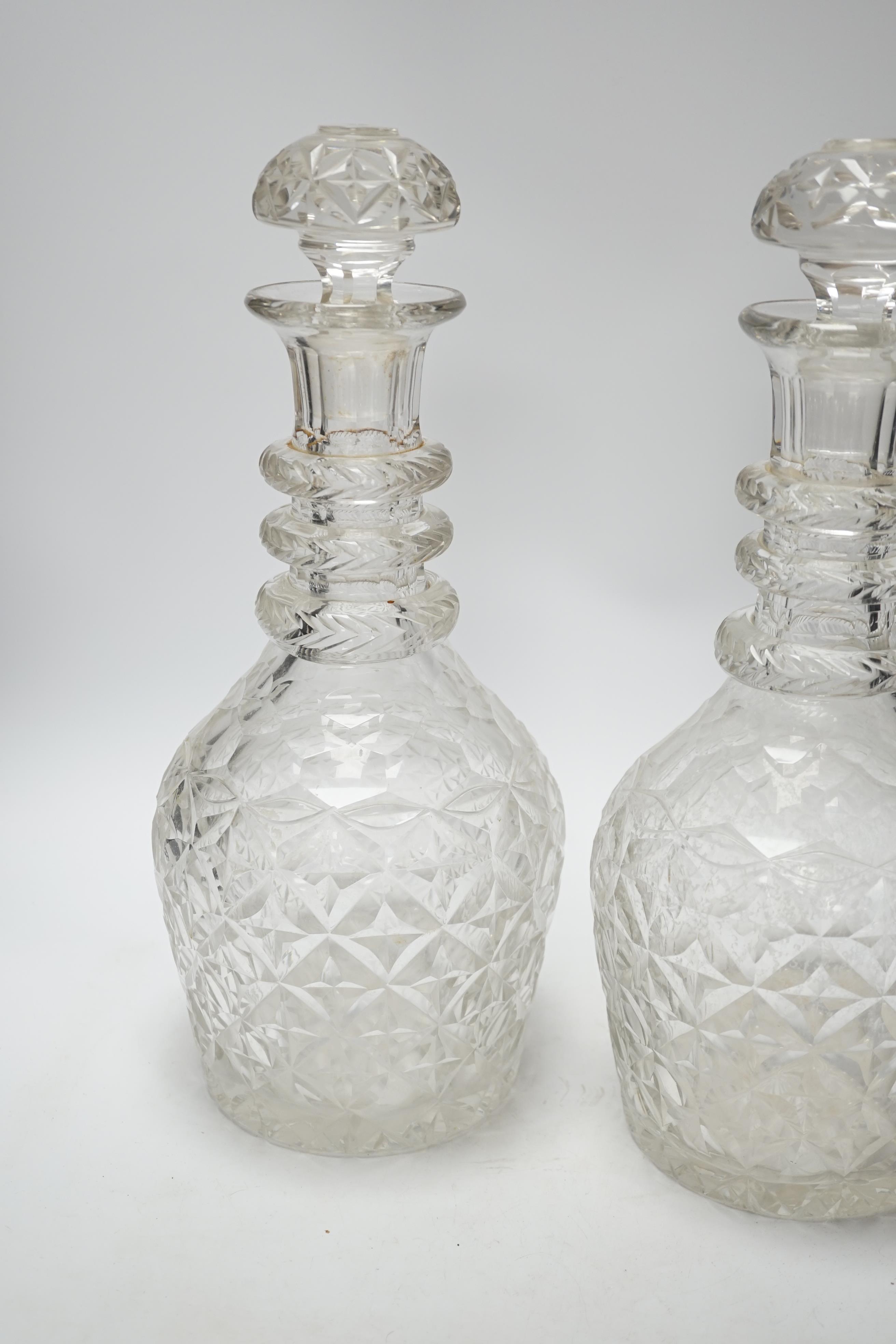 A pair of large Regency style cut glass magnum decanters and stoppers, 39cm high